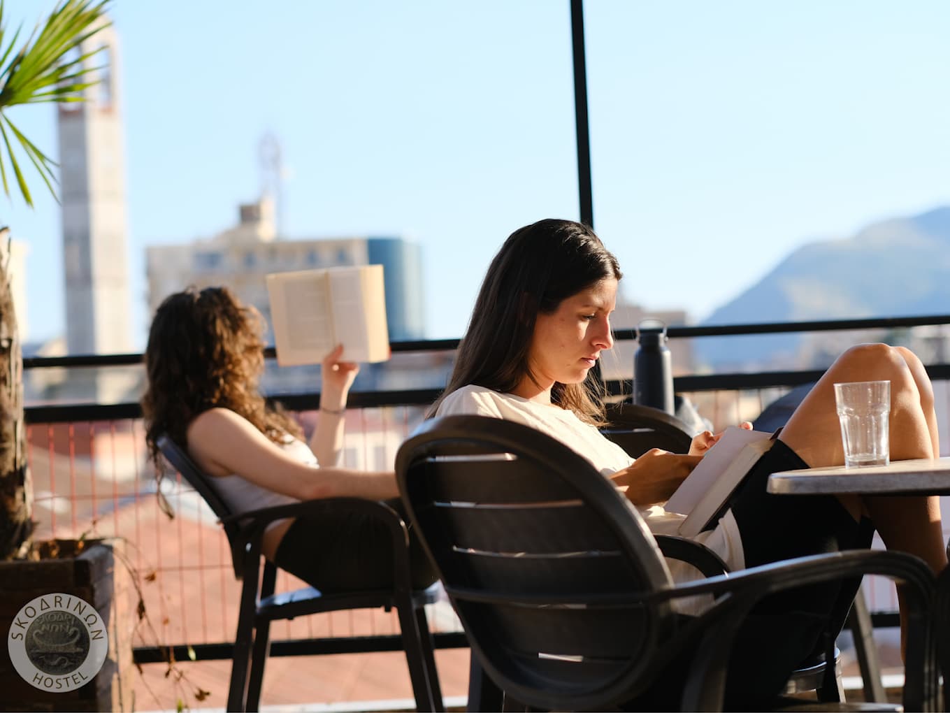 Guests relaxing on the rooftop terrace at Scodrinon Hostel