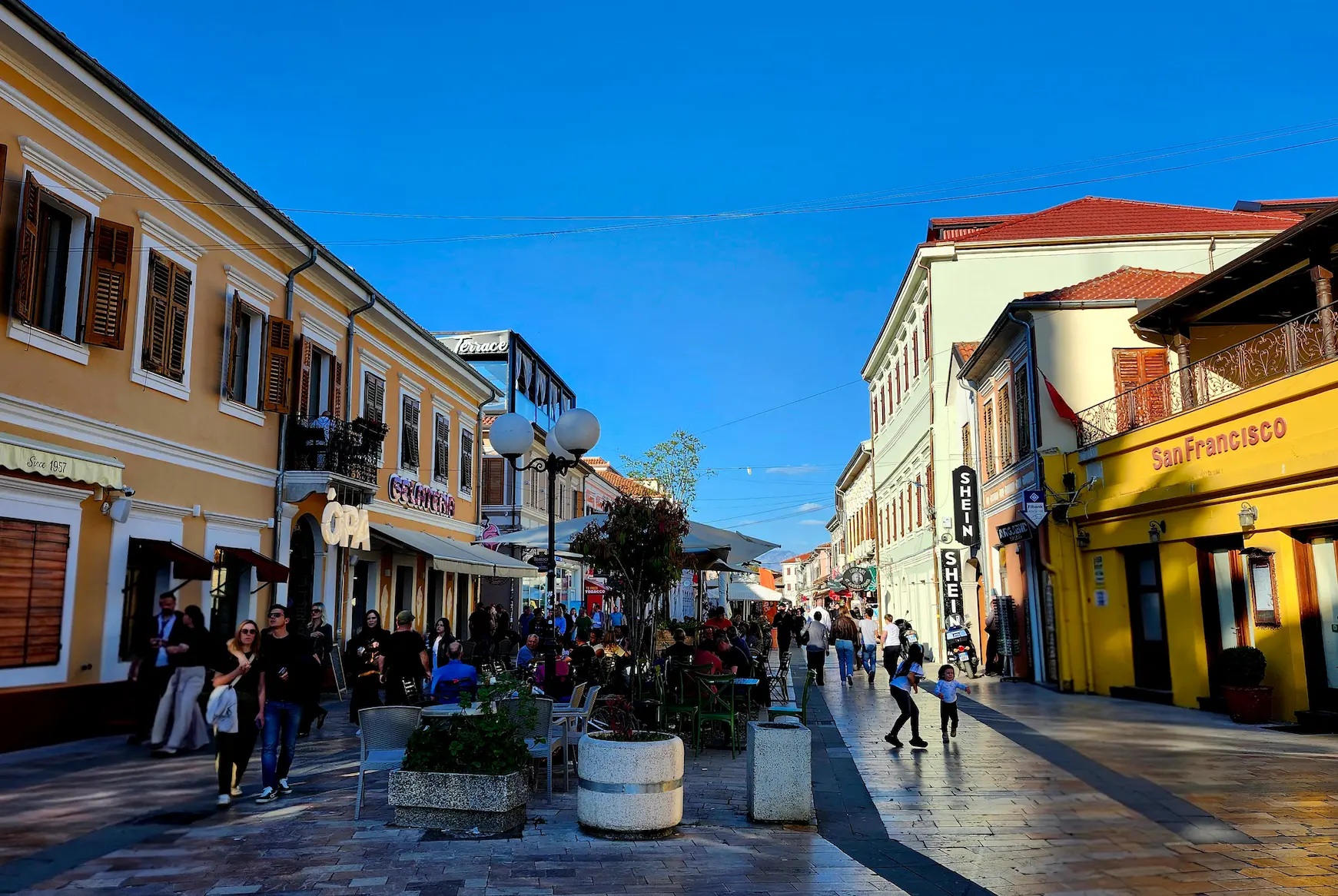 Kolë Idromeno pedestrian street life near Scodrinon Hostel